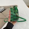 A Girl Carrying An Unconventional-shaped Bag Over Her Shoulder for Daily Commuting Purposes.