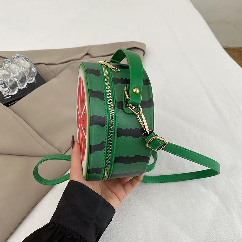 A Girl Carrying An Unconventional-shaped Bag Over Her Shoulder for Daily Commuting Purposes.