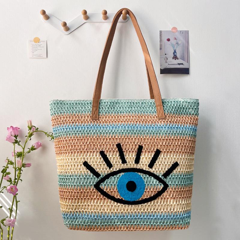 Große geflochtene Raffia-Strandtasche mit Augen-Print-Design und zwei Schultergurten für den Urlaub