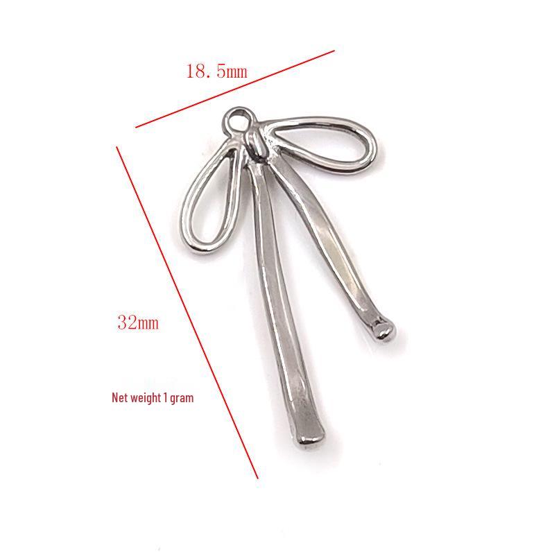 Gold Plated Stainless Steel Jewelry Set: Bow Tie Pendant Necklace, Bracelet, Earrings, and Charms.