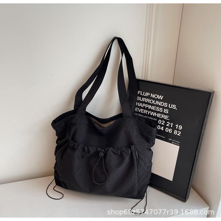 2025 new large-capacity drawstring canvas bag casual Korean version women's solid color daily commuting shoulder tote bag women