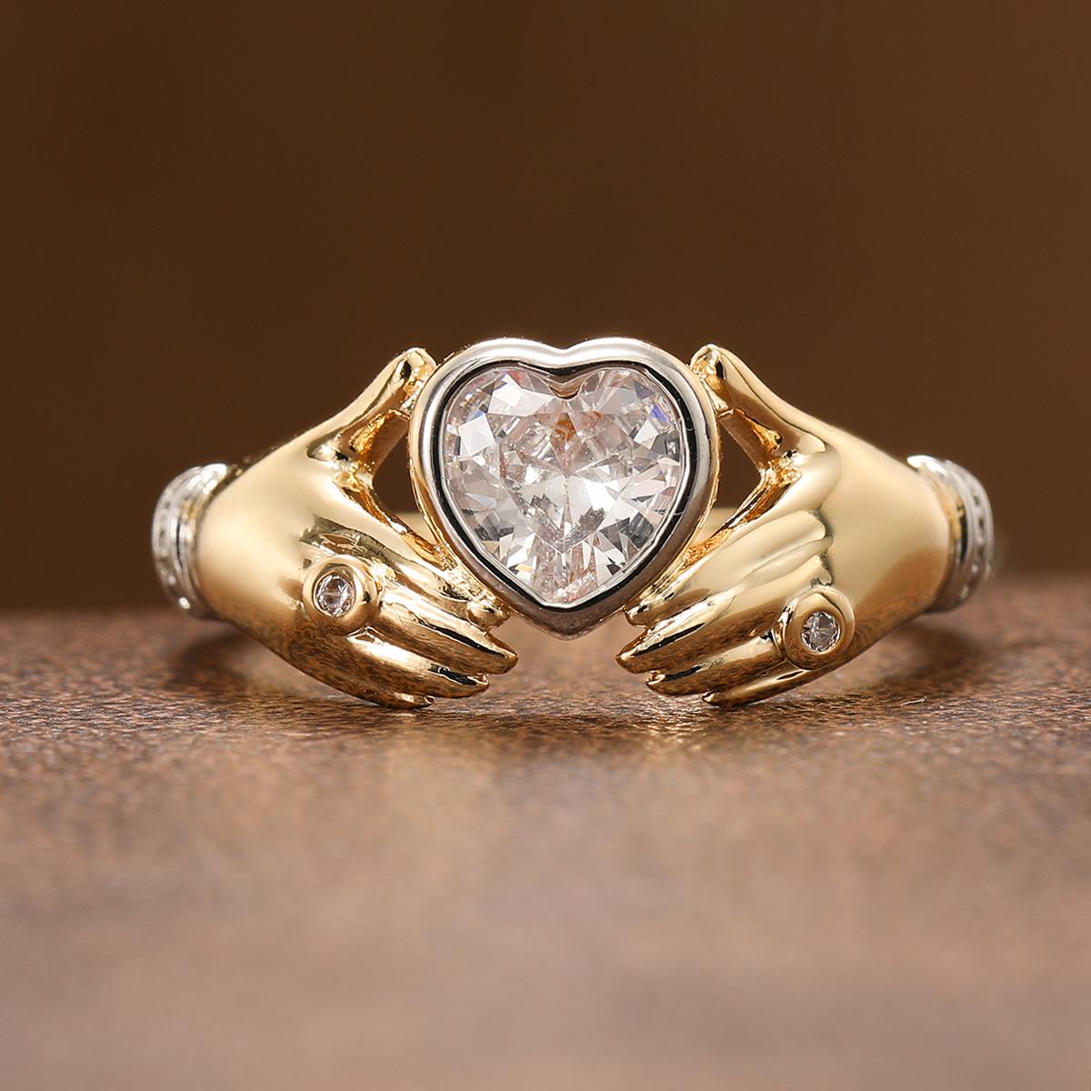 Luxurious hands holding a heart-shaped synthetic gemstone ring made of copper. Women s jewelry ring for a banquet. 9
