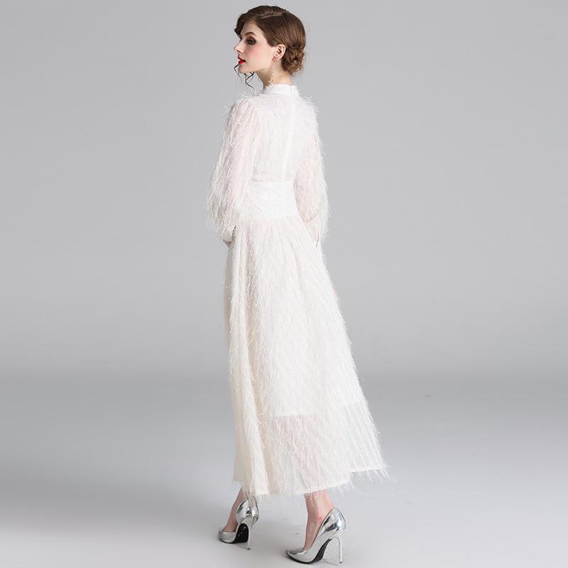 white dress with tassels on sleeves