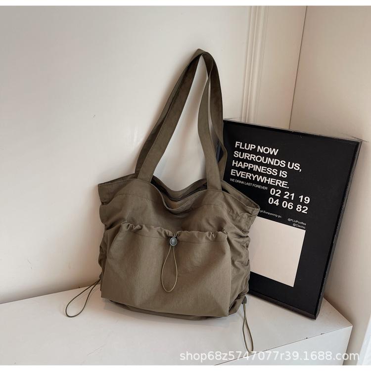2025 new large-capacity drawstring canvas bag casual Korean version women's solid color daily commuting shoulder tote bag women