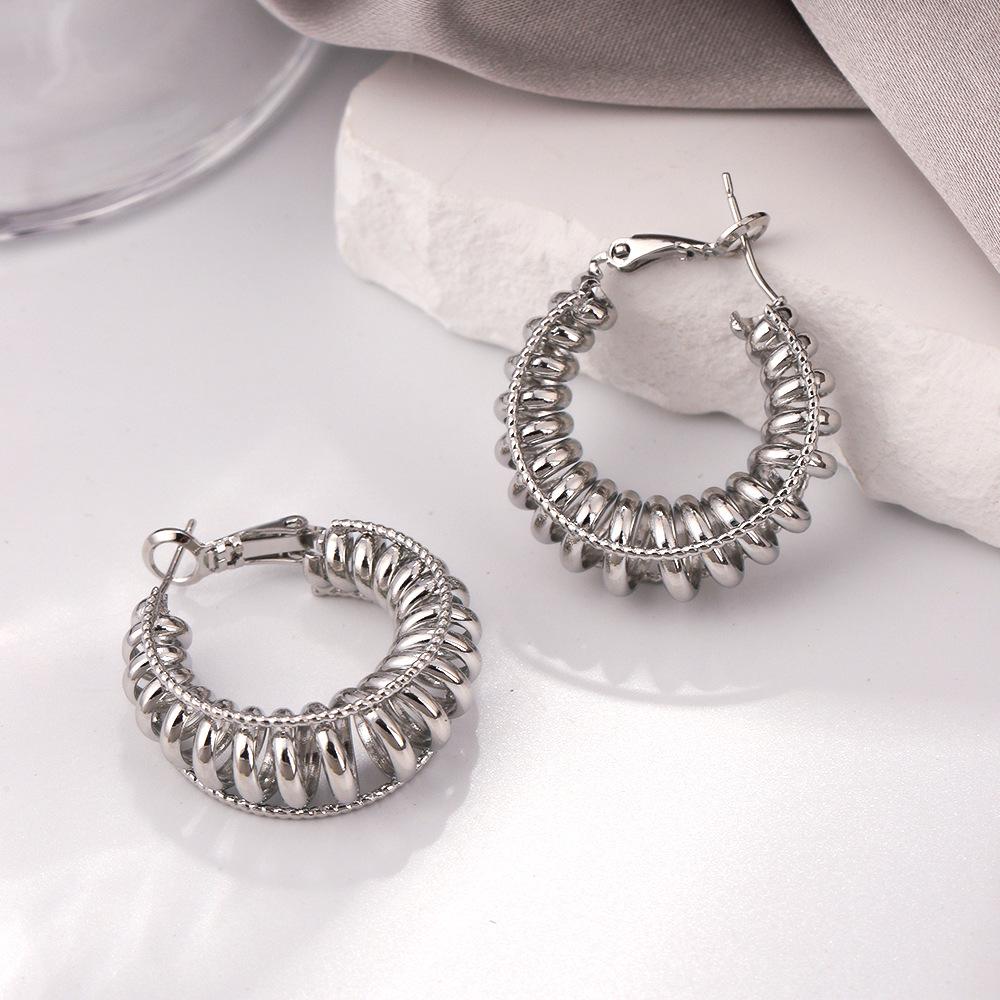 Women's High-End Light Luxury Twisted Hoop Earrings - Stylish, Colorfast, Exaggerated Design for Round and Square Faces.