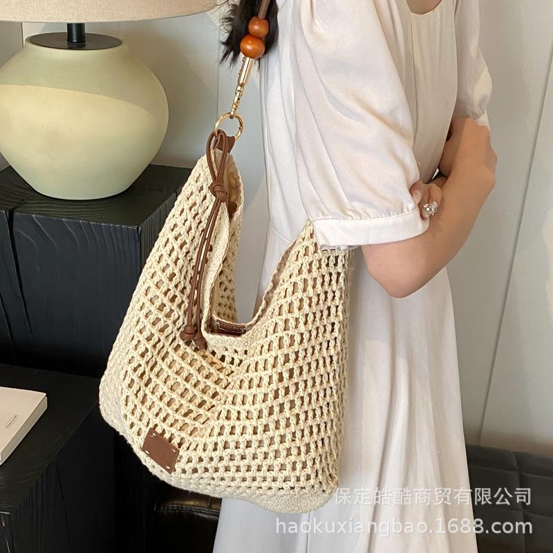 Woven hollow bag women's 2025 new spring and summer seaside vacation travel tote bag beach bag shoulder armpit bag
