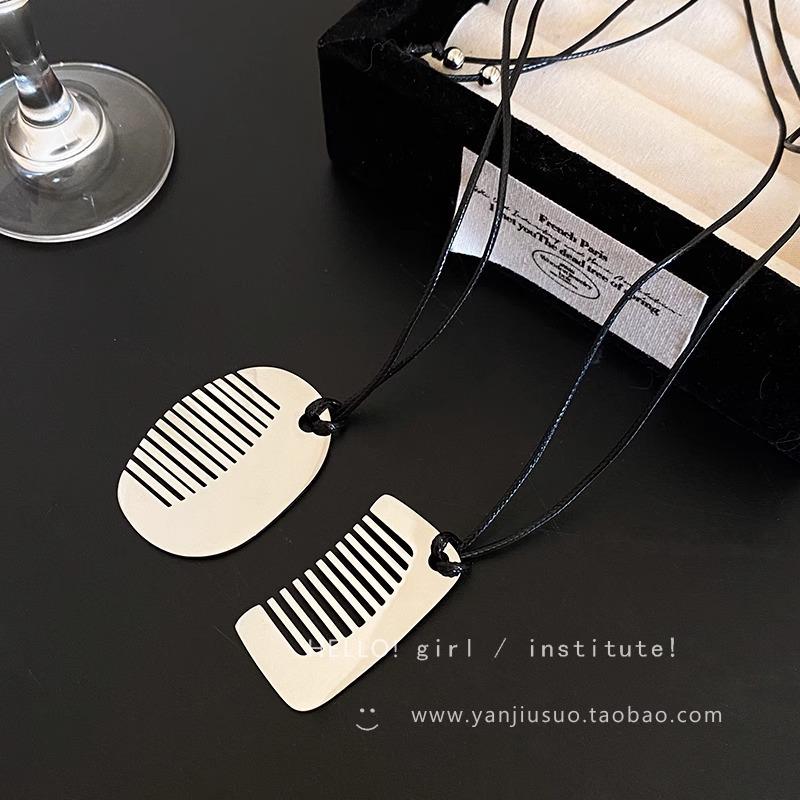 Fashion sense small comb titanium steel black rope pendant necklace women's high-end sweater chain long sweater chain accessories