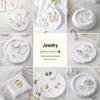 Trendy Jewelry Photography Props Set: Earrings, Necklaces, and Background Fabrics.