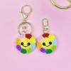 Bunte Sonnenblumen-Smiley-Gesicht Schlüsselanhänger & Handgefertigter Taschenanhänger - Ohrhörerhüllen-Dekoration für Damen & Kindertag Geschenk