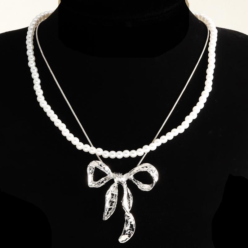 European & American Summer Fashion: Layered Alloy Bow Tie Necklace with Faux Pearl.