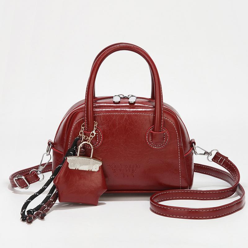 Tragbare Bowlingtasche Damen 2025 neue Frühjahrs- und Sommer-Mode strukturierte Schalentasche vielseitige Damen-Umhängetasche