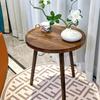 A Simple, Casual and Artistic Small Round Table Beside the Balcony Sofa, a Small Round Table and a Small Coffee Table