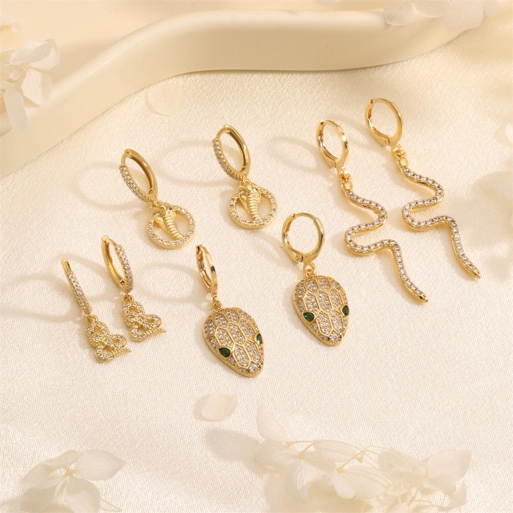 

Exotic Emerald & Zircon Snake Ear Cuffs: Bold, Fashionable Statement Earrings