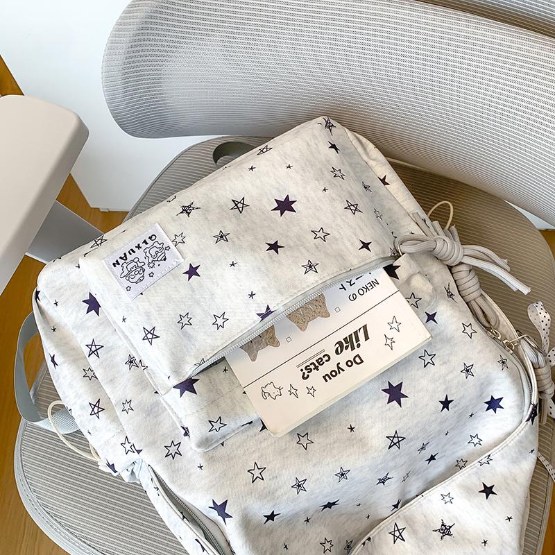 Star-Printed Backpack with Front Zipper Pocket and Tassel Details for School and Daily Use