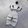 Set due pezzi pantaloni e maglione a contrasto nero e grigio stile europeo e americano abbigliamento sportivo casual con cappuccio ampio da uomo e donna