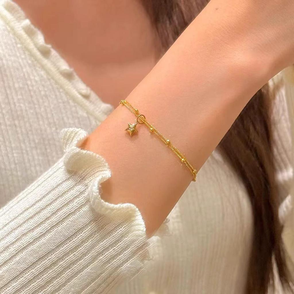 Gold Double-Layer Star Pendant Bracelet for Women - Small Wrist Design, Unique & Elegant.