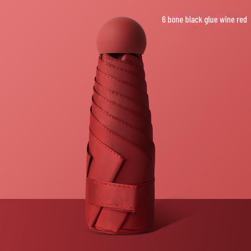 50 % rabatt på svart kapselparaply i lommeformat - Seks-skjerms sammenleggbar for sol og regn