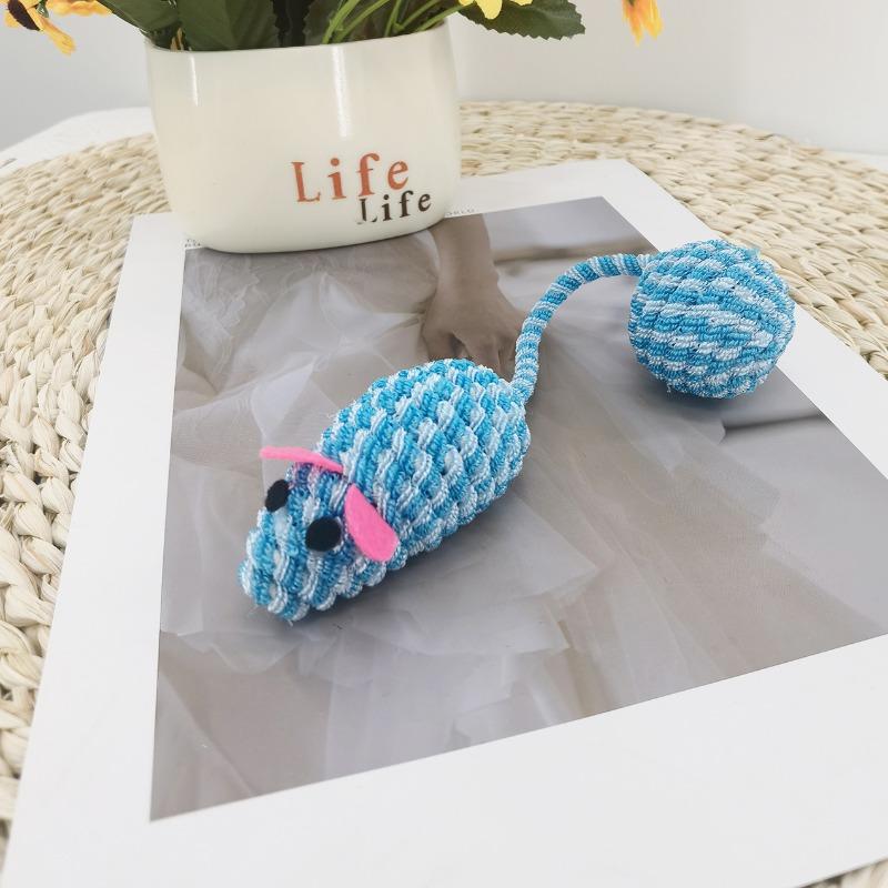 The Cat Is Chewing on The Toy Mouse, A Colorful Knitted Mouse Ball Toy That Makes A Rustling Sound. It s A Self-amusing Toy for Pets. синий