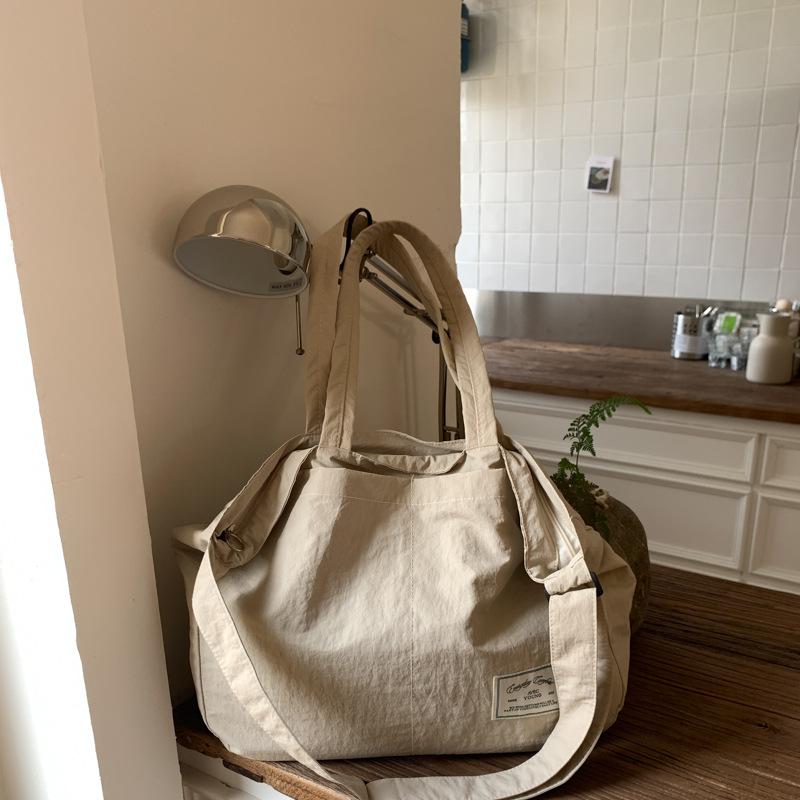 Canvas bag crossbody female Korean version fashionable simple large capacity student class lightweight simple solid color portable shopping bag