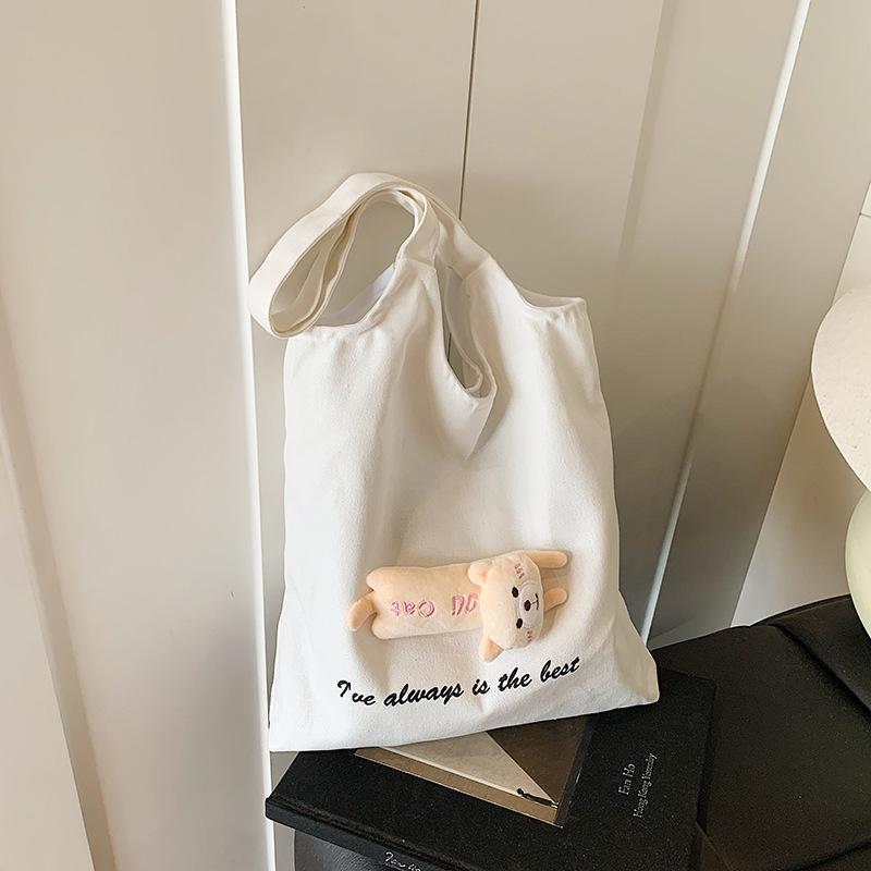 

Cute doll canvas bag bag fashion women lazy wind niche large capacity student commuting shoulder tote bag