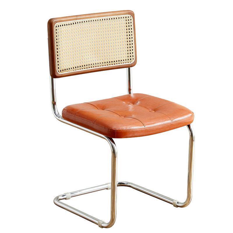 Elegantly crafted armless rattan dining chair in retro pastoral style, perfect for cafes, guesthouses, and vintage settings.