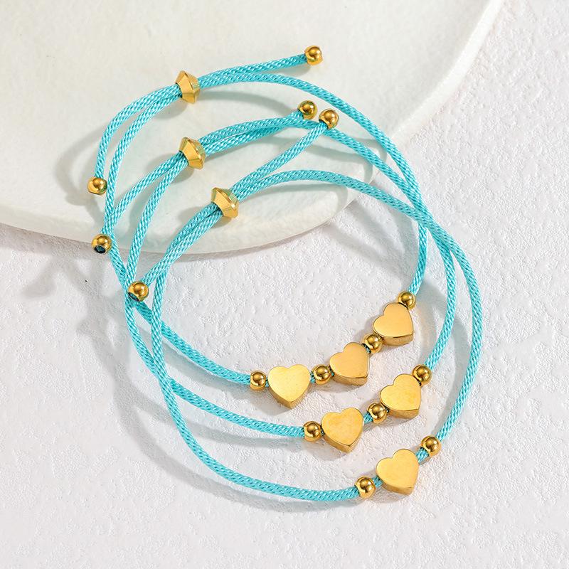Minimalistisches blaues Seilarmband mit Herz-, Männchen- und runden Anhängern aus Edelstahl