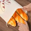 A reusable linen bread storage bag - an unbleached drawstring bag for the natural storage of homemade bread and pastries