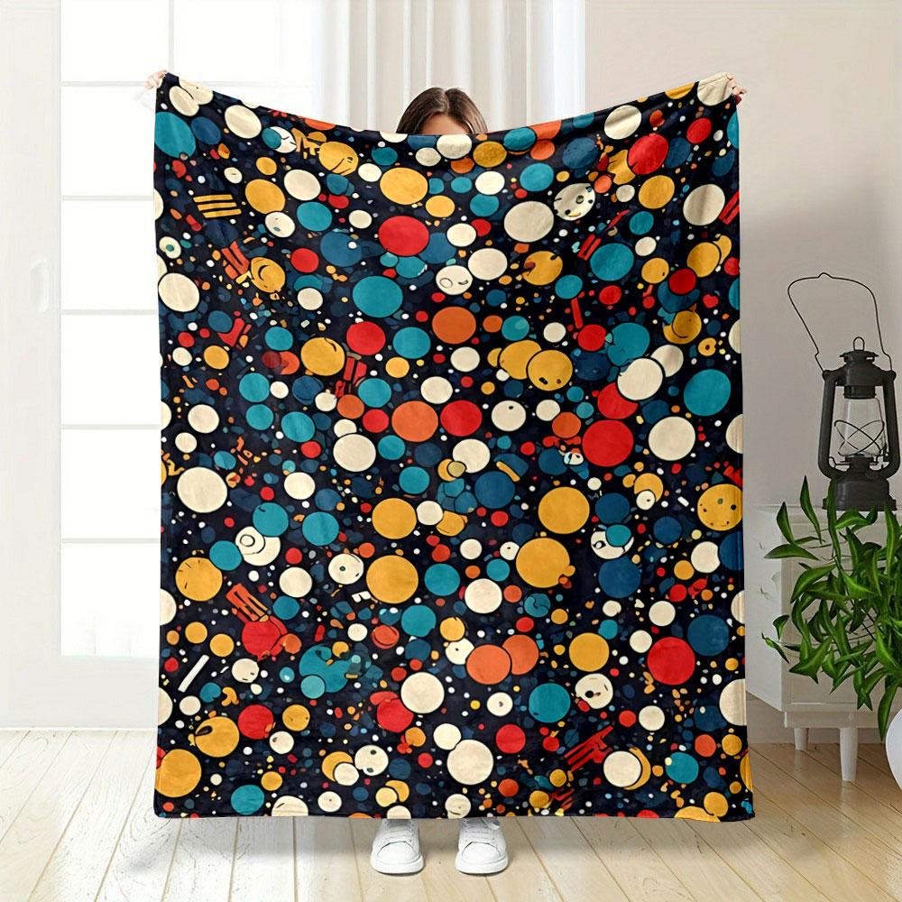 A colorful pattern of varying-sized circles with smiling faces on dark. for all seasons blanket lunch break throw gift