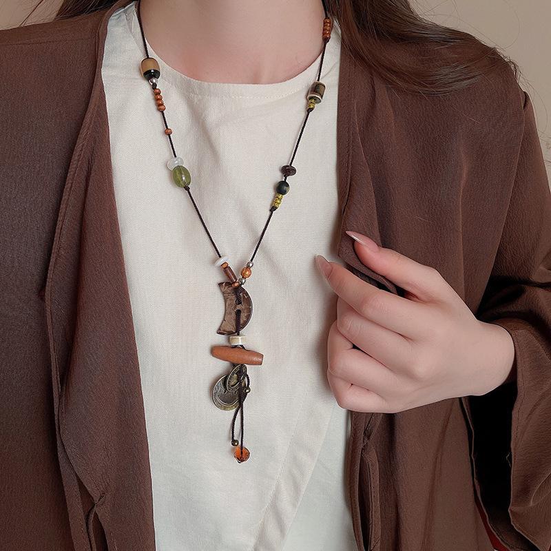 

Інфлюенсер Шкіряна Сумка для Монет та Навушників Намисто: Висококласний, універсальний ланцюжок для светра, модна біжутерія