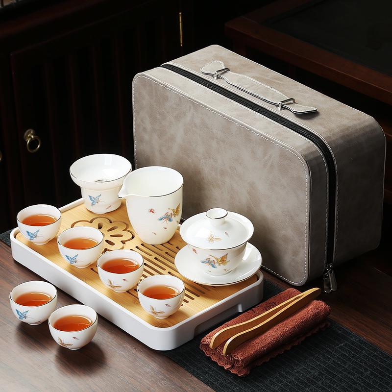 Compact Jade White Ceramic Travel Tea Set with Gaiwan, Cup, and Tray for Portable Kung Fu Tea Sessions.