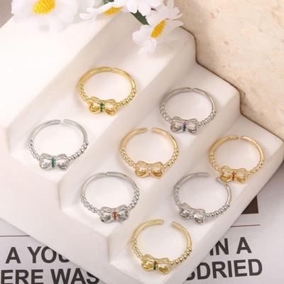 Kupferbeschichteter 18 Karat Gold Schmetterlingsknotenring mit mikro-besetzten Diamanten, Frischer Imitations-Eheringschmuck