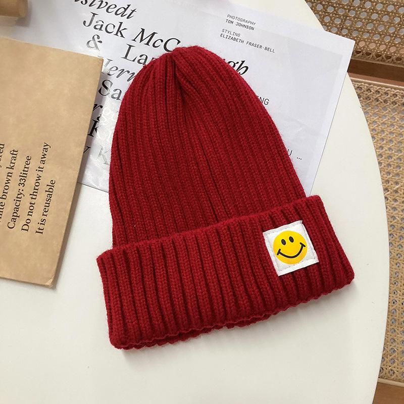 Smiley face label wool hat female autumn and winter warm bag head couple trendy brand cold hat solid color student male knitted hat