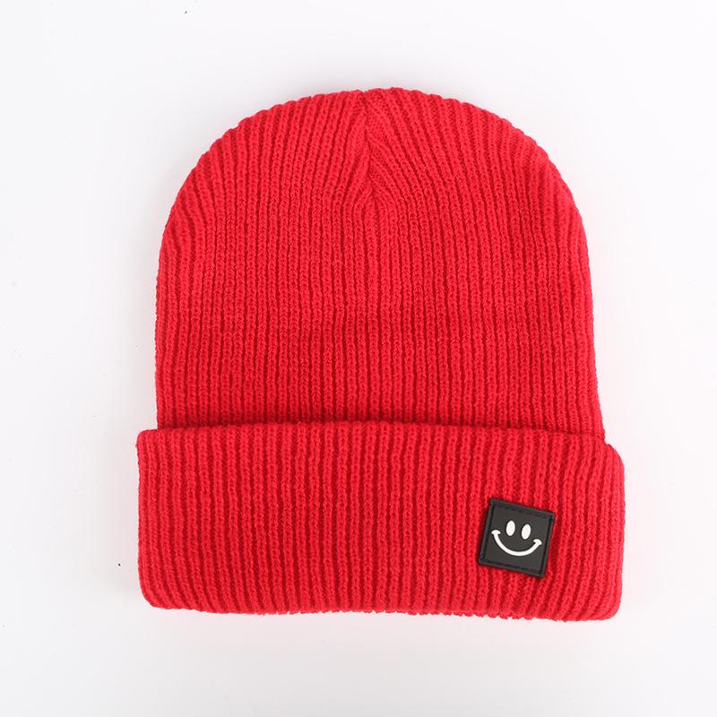Autumn and winter smiley face labeling wool hat solid color couple versatile warm knitting classic casual hat men and women tide