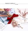 Korean-Style Handmade Rhinestone Perfume Bottle Keychain with Bow and Pearl Charm