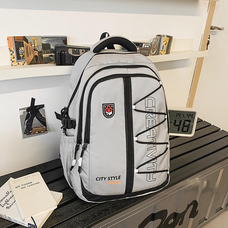High-value retro tooling trendy and cool backpack for junior high school students, casual, simple, lightweight and large-capacity backpack.