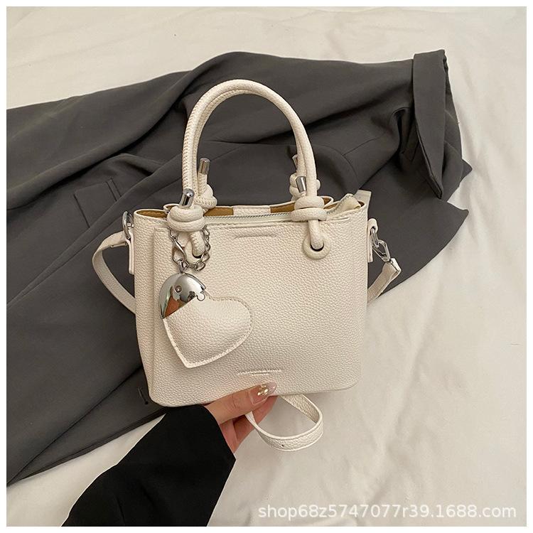 

2025 spring new fashionable simple fashionable texture lychee pattern portable bucket bag foreign style commuter messenger women s bag белый