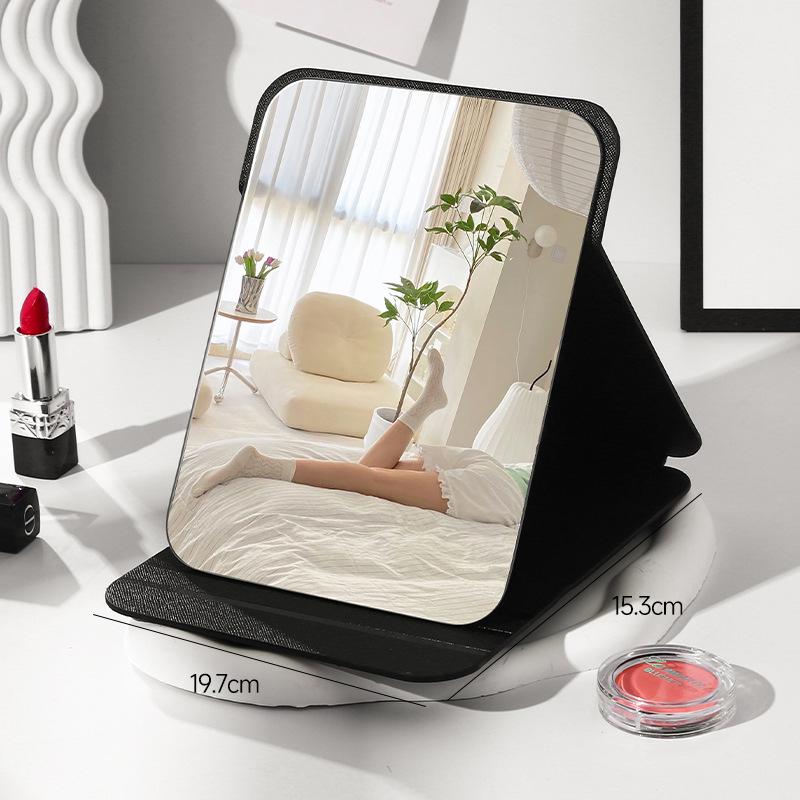 

Compact Folding Mirror: Portable Dressing & Makeup Mirror for Dorms, Travel, and Home. Ideal for Students and Both Men and Women.