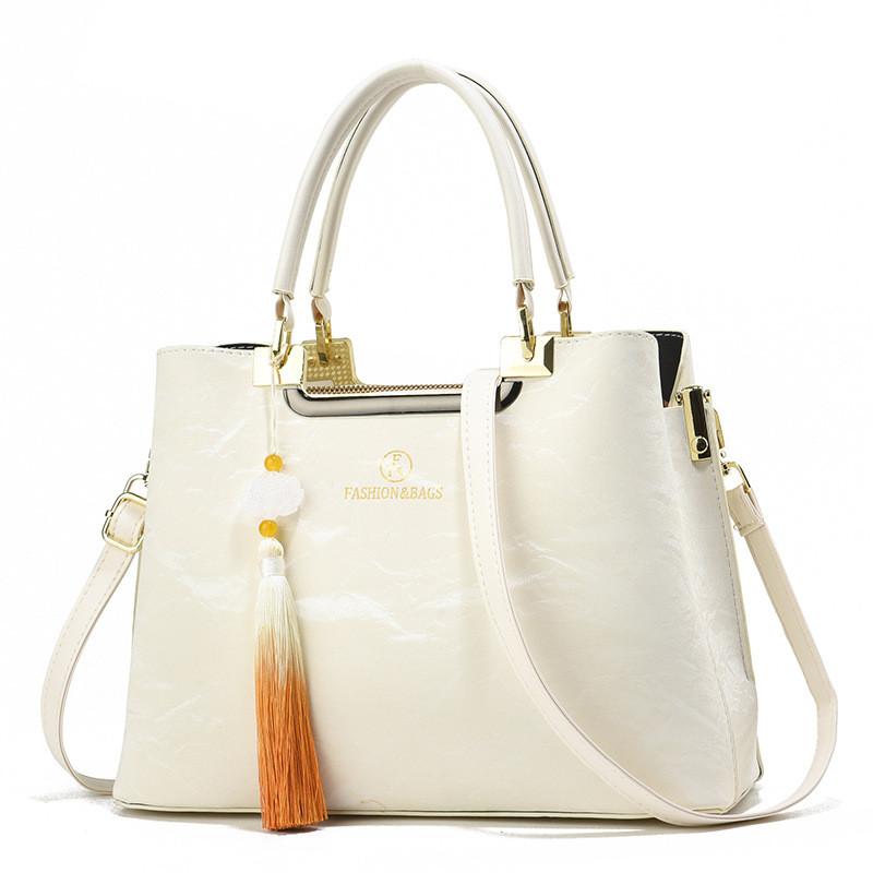 

Fashionable Medium Sized Women s Handbag With Chic Tassel Detail Perfect For Everyday Use In Multiple Colors бежевый