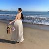 New white seaside vacation, high-end neck hanging, big halter, long skirt pleated, loose and thin, big pendulum Sanya sand