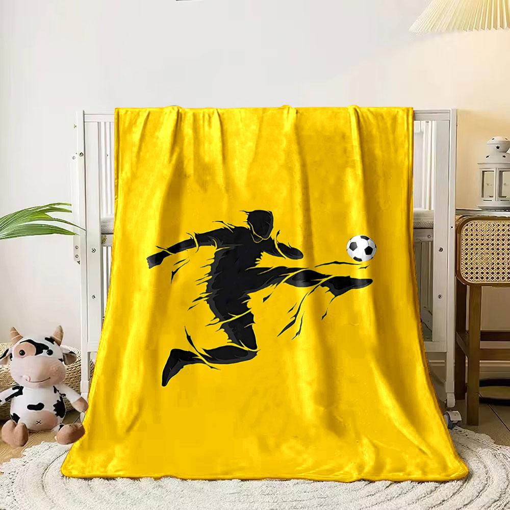 

A silhouette of a soccer player mid-kick with a ball on a yellow background. for all seasons blanket lunch break throw gift 80cm x 120cm