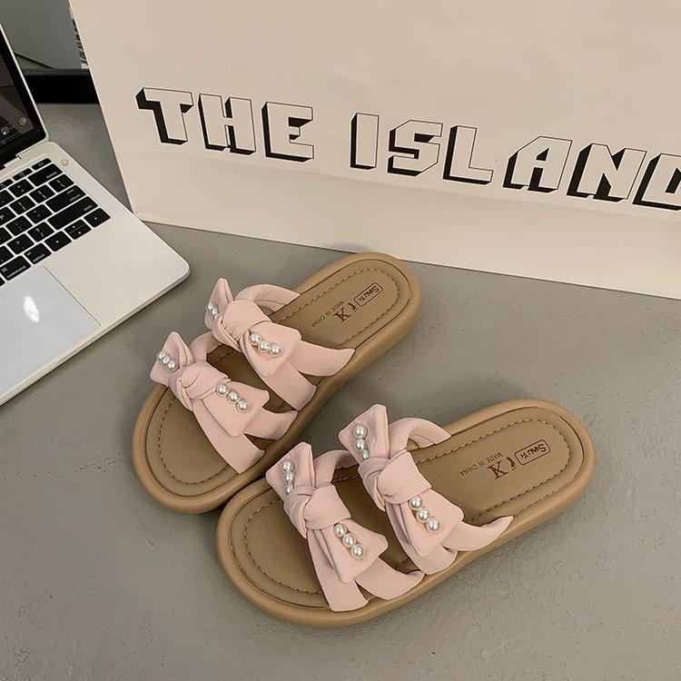 

Stepping on shit feels thick-soled one-word sandals for women s summer wear 2025 new French skirt pearl bow beach shoes 40