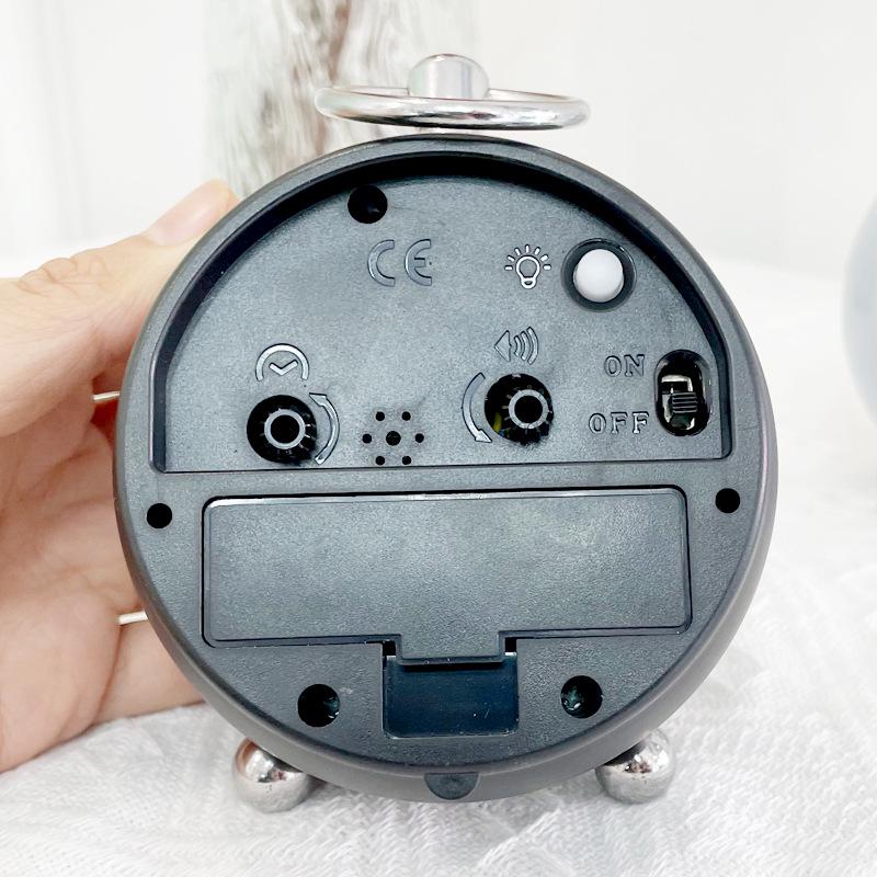Silent Metal Alarm Clock with Night Light and Gold Stamped Spherical Face - Perfect for Students and Children.
