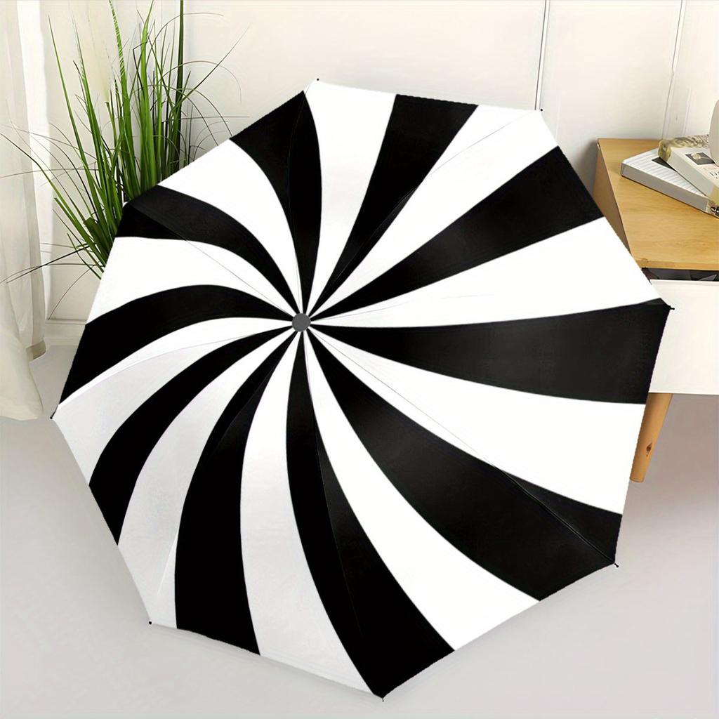 A Black And White Spiral Patterned Automatic Folding Umbrella. It Features a Portable And Collapsible Design, Making It a Casual Outdoor Acc