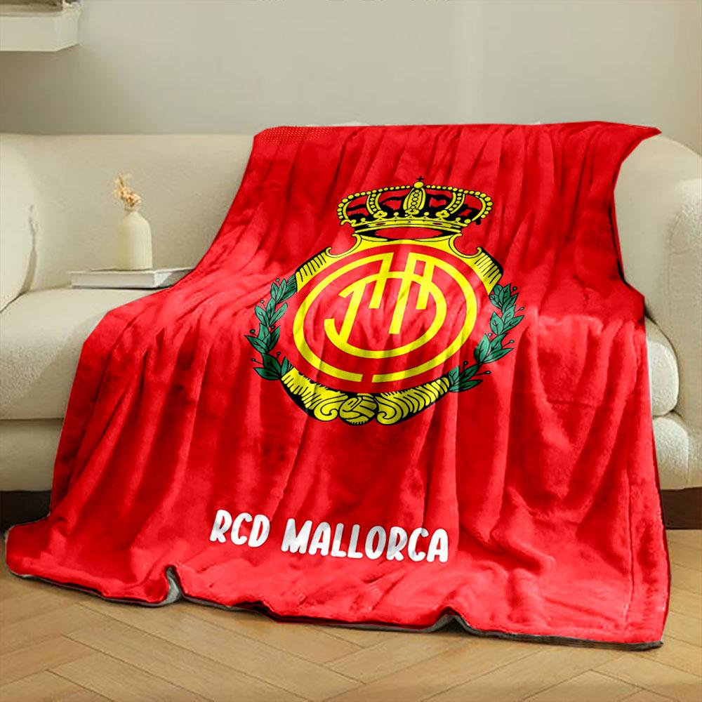 A crowned emblem with yellow circular patterns on a red background. for all seasons blanket lunch break throw gift