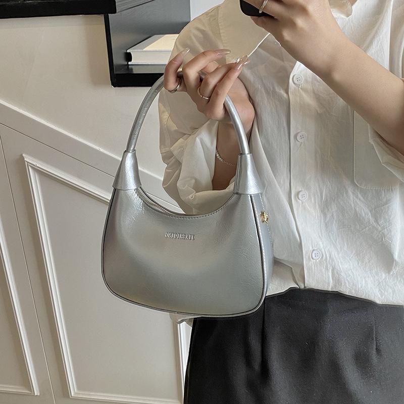 Fashion birth girl small bag 2025 new patent leather design sense portable crescent bag hand carry niche unique underarm bag