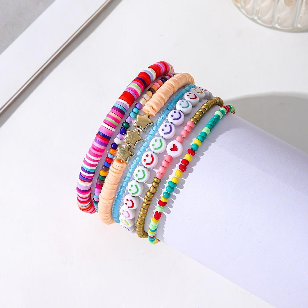 Korean version of fashion new multi-layer elastic thread soft pottery love smiley face bracelet set retro handmade pearl jewelry women