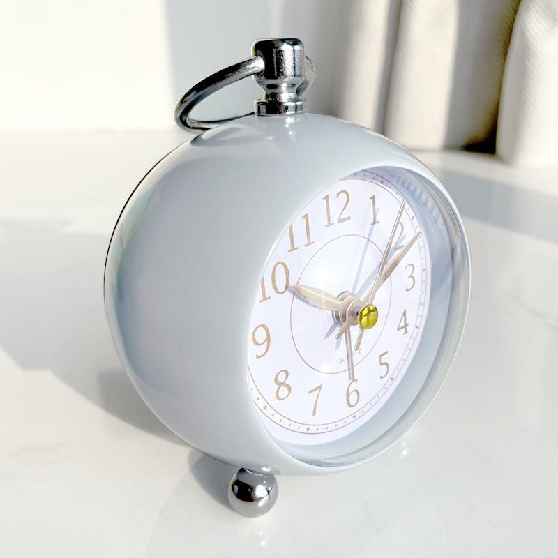 Silent Metal Alarm Clock with Night Light and Gold Stamped Spherical Face - Perfect for Students and Children.