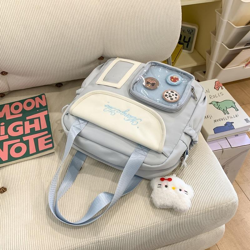 Japanische Schmerzbeutel Umhängetasche Damen Neue modische große Kapazität tragbare Tragetasche vielseitige Studenten-Schultertasche Trend