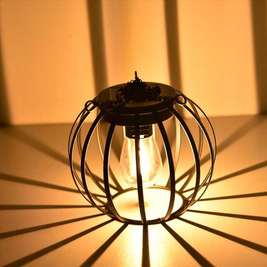 Solar Wrought Iron Lantern Light: Retro Mesh Pendant for Outdoor Garden, Courtyard, and Balcony Ambiance.