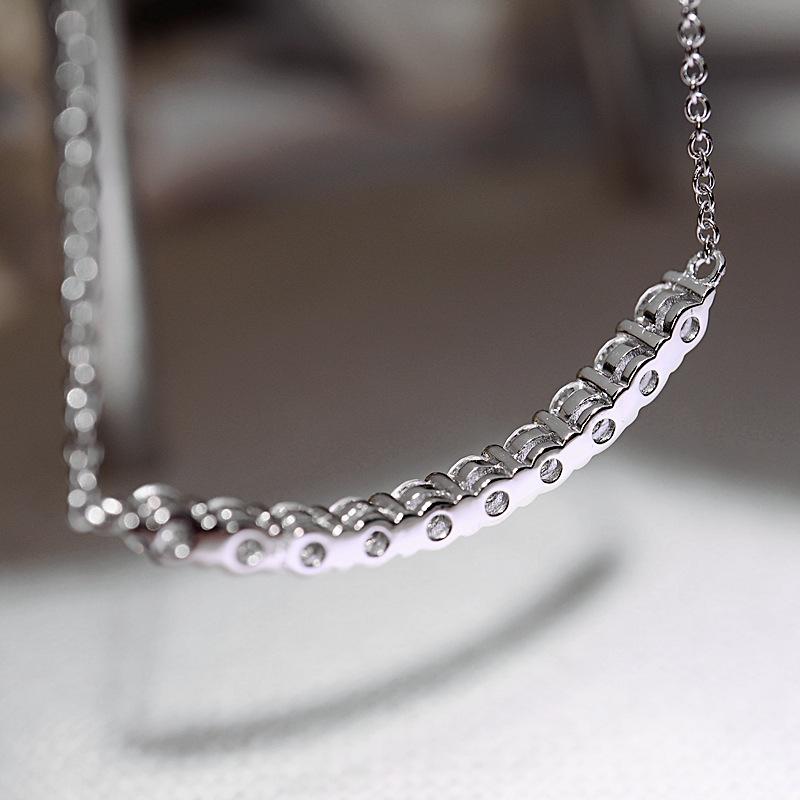 Curved smile pendant necklace, set with zircon stones